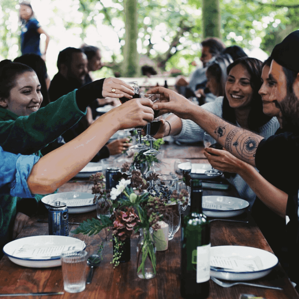 Guests toasting with a glass of wine at a woodland supper club